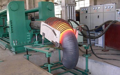 Mid-frequency extruding machine for the forming of nickel alloy elbows.